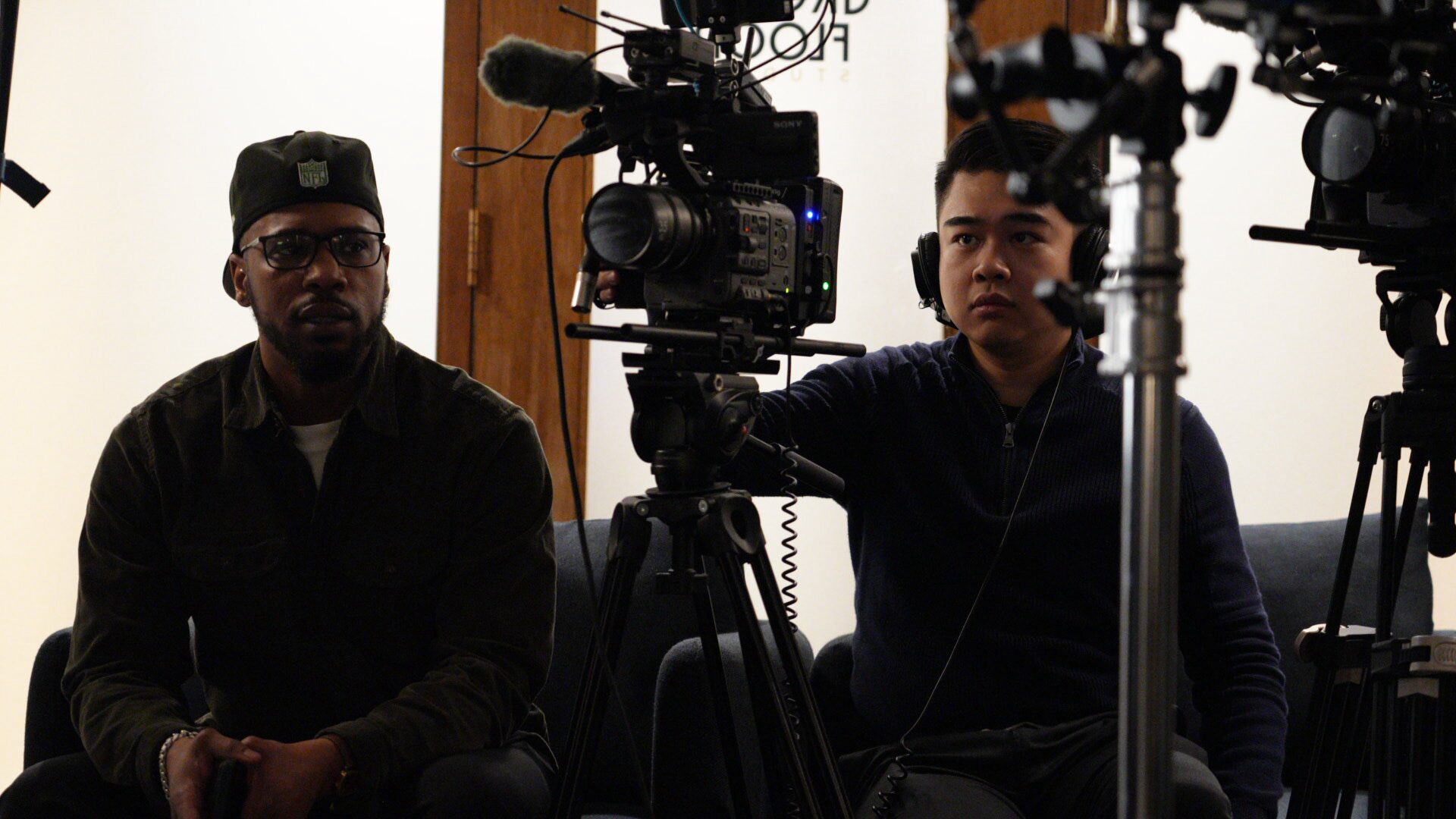 Crew members beside a camera between takes