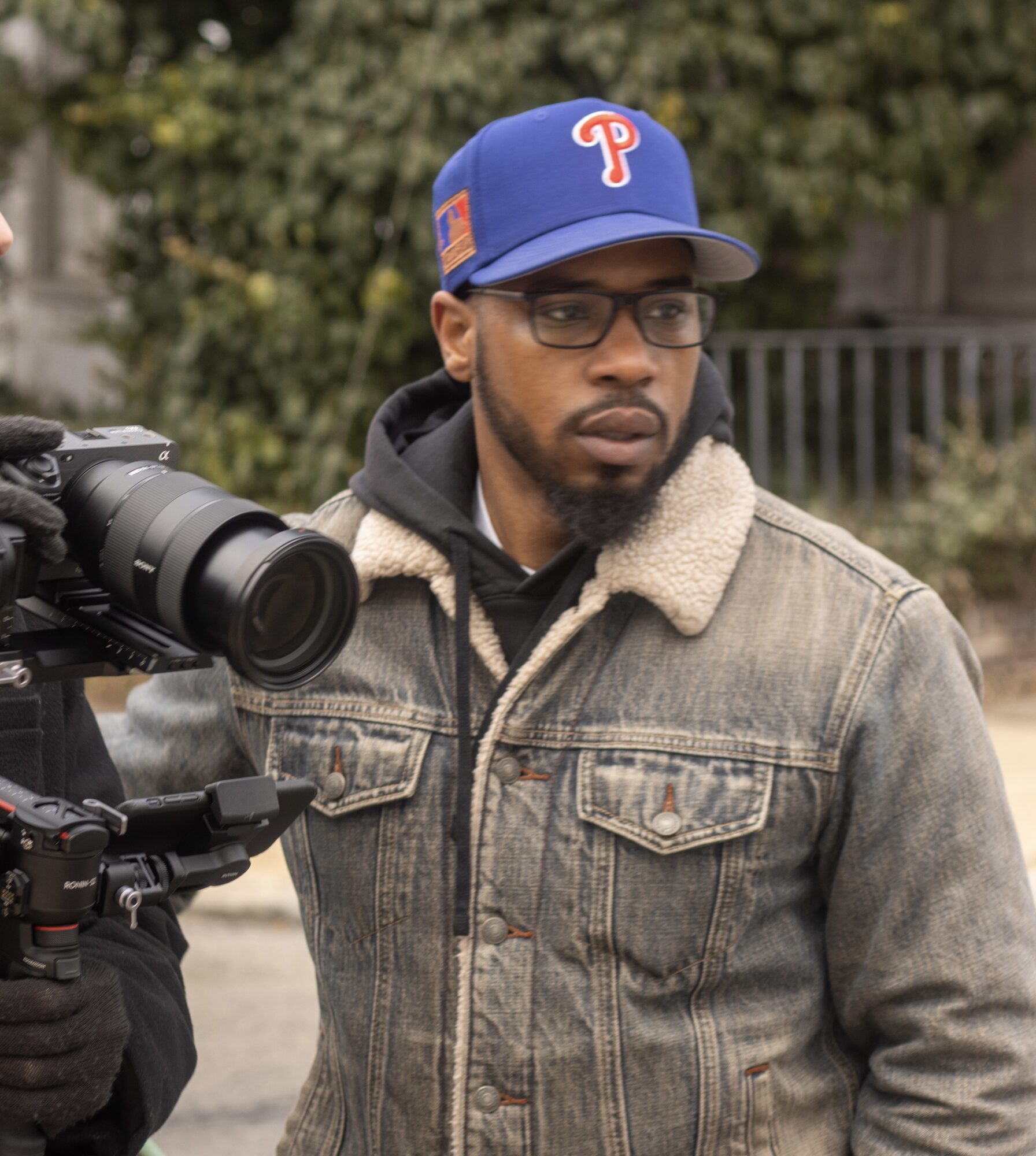Shuja Moore behind a camera on location