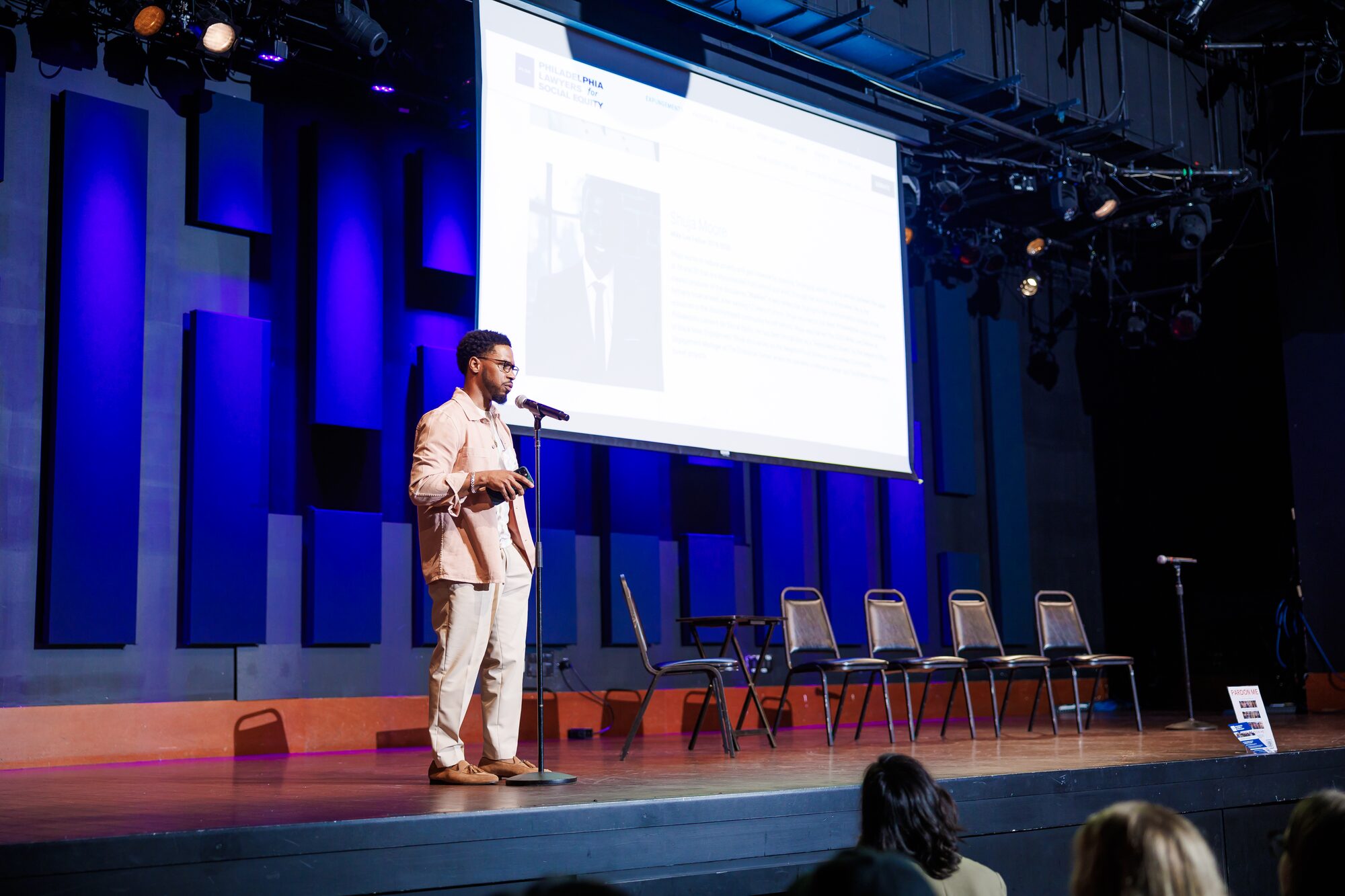 Speaking on stage during a screening event